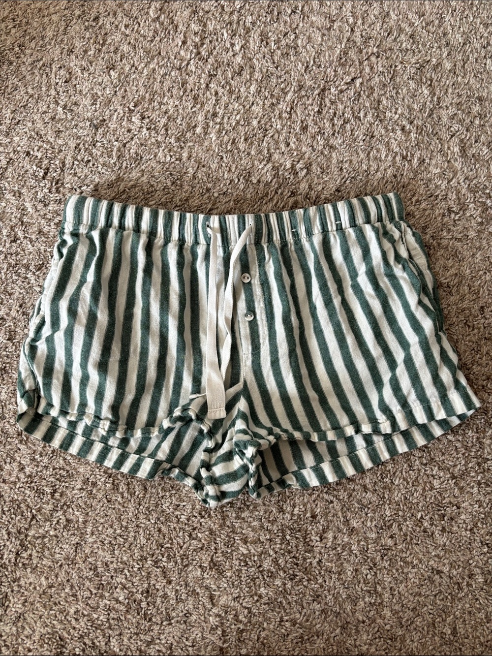 Stars above green and white striped pajama shorts